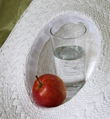 Glass with water and apple