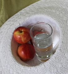 Glass of water and apples from above
