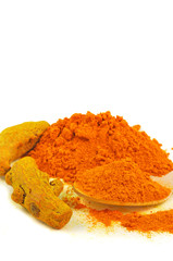 whole and  turmeric powder arranged on white