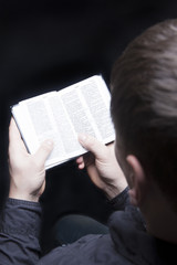 man on knees with bible