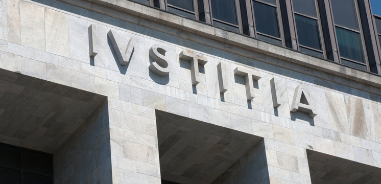 Iustitia - embossed marble justice latin word on corthouse