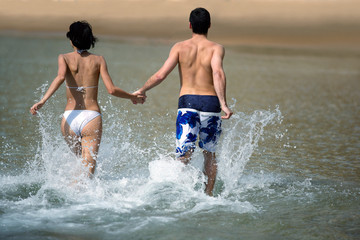 Couple running through the water