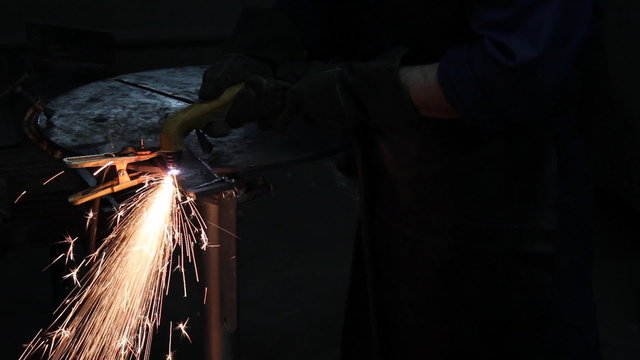 Worker cutting steel in a workshop