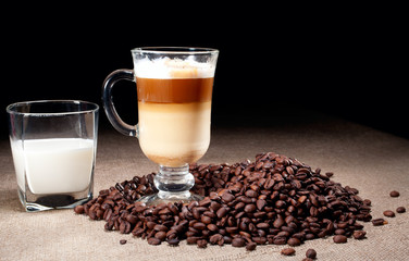 Cappuccino glass with coffee beans and glass of milk