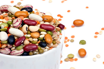 Legumes and cereales close up in white cup isolated