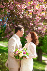Beautiful newlywed couple in park at spring