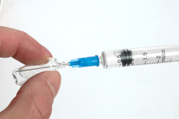 The disposable syringe gathers solution from an ampoule