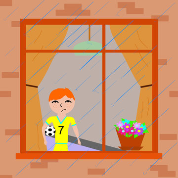 boy near the window watching the rain