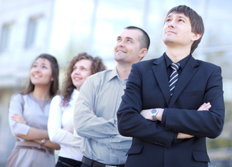 business team standing in a row at office and looking upwards