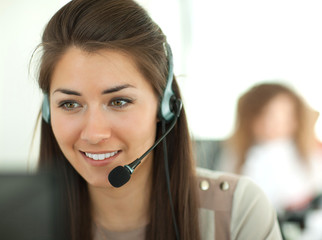 Female customer support operator with headset and smiling - obrazy, fototapety, plakaty