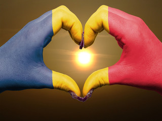 Heart and love gesture by hands colored in chad flag during beau
