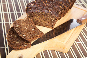 Slices cut black bread with  knife