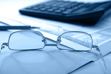 pen and calculator on stocks