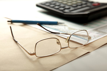 pen and calculator on stocks