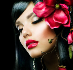 Fashion Brunette Girl with Magnolia Flower isolated on Black
