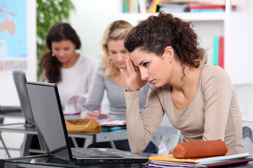 Three female students with laptops