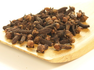 Cloves on tray, closeup, isolated