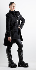 standing woman wearing extravagant clothes and boots