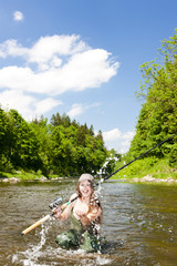 woman fishing in river, Czech Republic