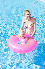 mother with her daughter in swimming pool