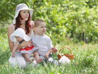 mother and two children on natural background