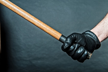 black leather glove and a stick