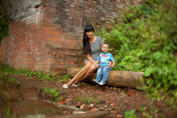 a little boy in a blue shirt with his mother