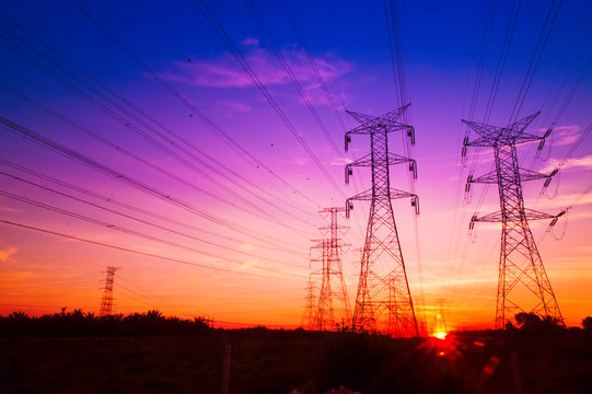 Fototapeta Electricity pylons at sunset