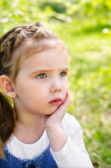 Portrait of thinking little girl outdoor