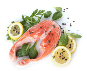 Red fish with lemon, parsley and pepper isolated on white.