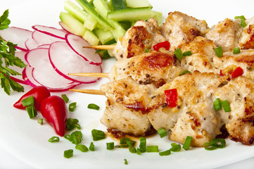 barbecue chicken on a white plate with vegetables