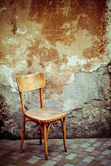 Vintage chair near old wall