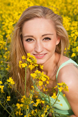 beautiful blonde girl in a field in summer