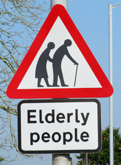 British elderly people crossing road warning sign.