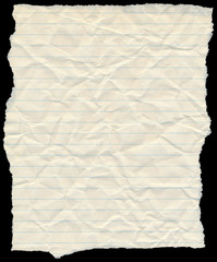 Old yellowing crumpled lined paper torn edges isolated on black.