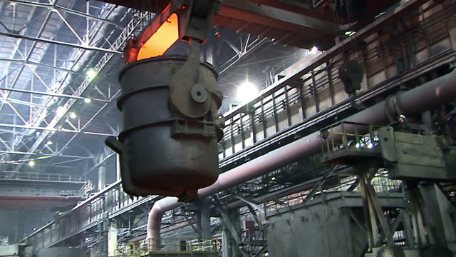 Steel Works. A huge crane transports the ladle of molten metal.