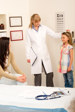 Medical check-up at pediatrist girl measure height