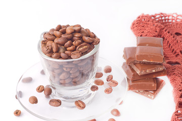 Clear cup with coffee beans around
