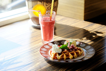 Waffle with icecream and glass of smoothie