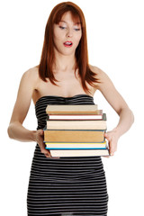 Shocked student girl holding books