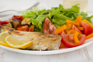 fried fish with vegetables and salad