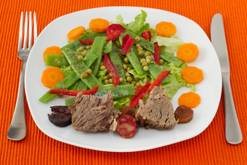 boiled meat with sausages and vegetable salad