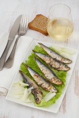 fried sardines on lettuce