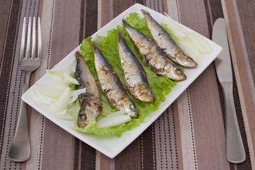 fried sardines on lettuce