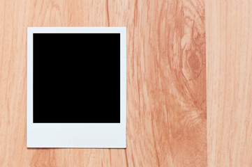 old, blank picture  on table. picture on wooden background