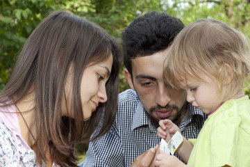 Teen couple with little girl