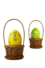 Near yellow Easter egg into a basket