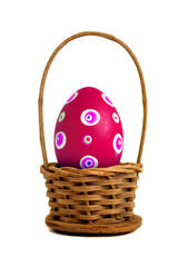 Single Easter egg into a basket