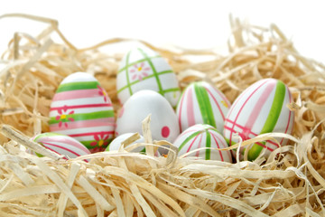 Easter eggs into a nest from bottom