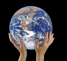 Planet earth on palms.Elements of this image furnished by NASA